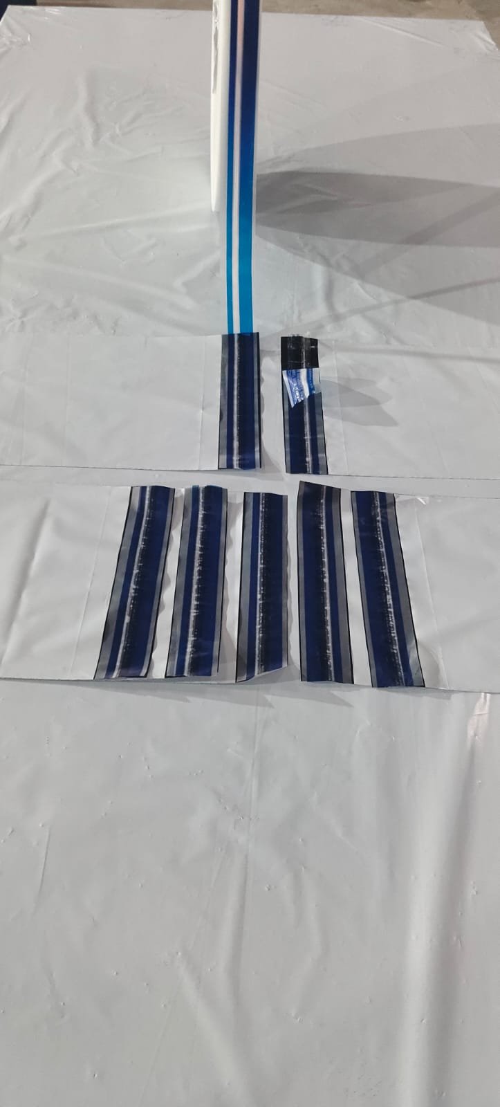 Blue Level 4 film unwinding onto poly bags with several seals lifted to reveal the transferred message