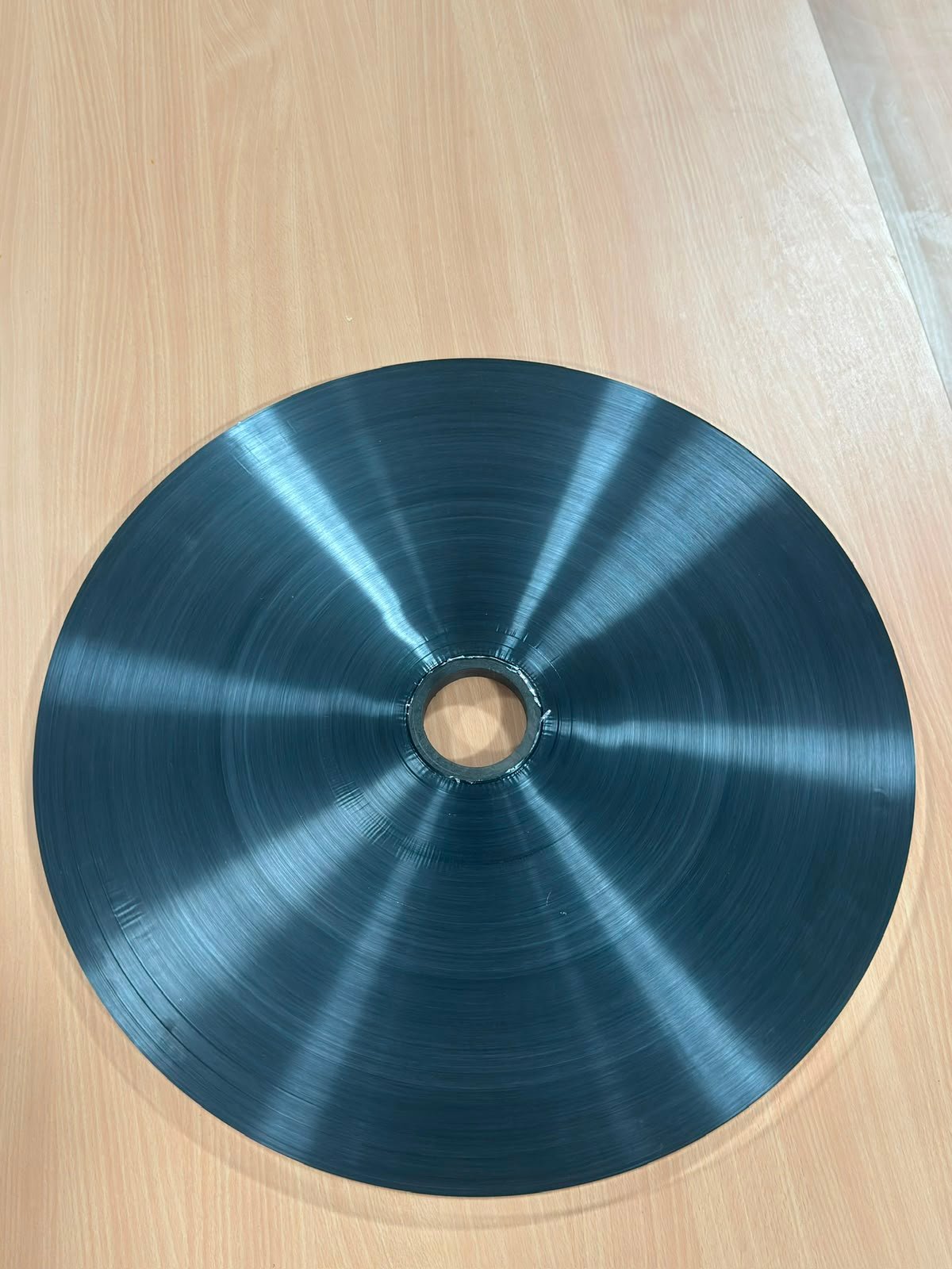 Pancake-wound silicone-coated metallised film on a 3 inch core, viewed face on